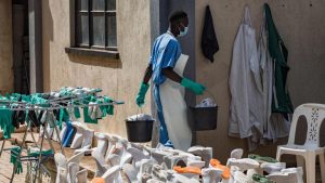 A health worker cleans PPE at the Mulago National Referral Hospital isolation unit in Kampala, Uganda, on July 8. - Badru Katumba/AFP/Getty Images